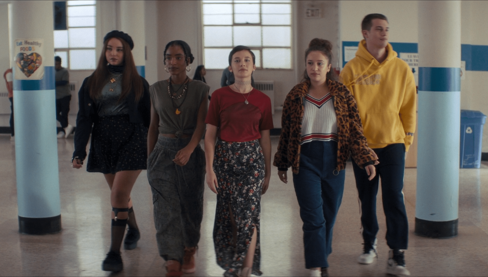A group of people walking down a hallway. Description generated by AI