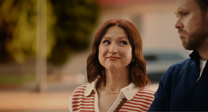 A woman with a red striped shirt and a man in a blue shirt. Description generated by AI