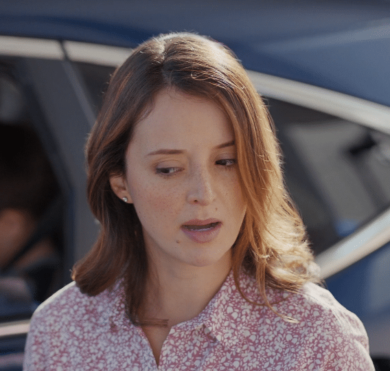 A woman wearing a pink shirt. Description generated by AI