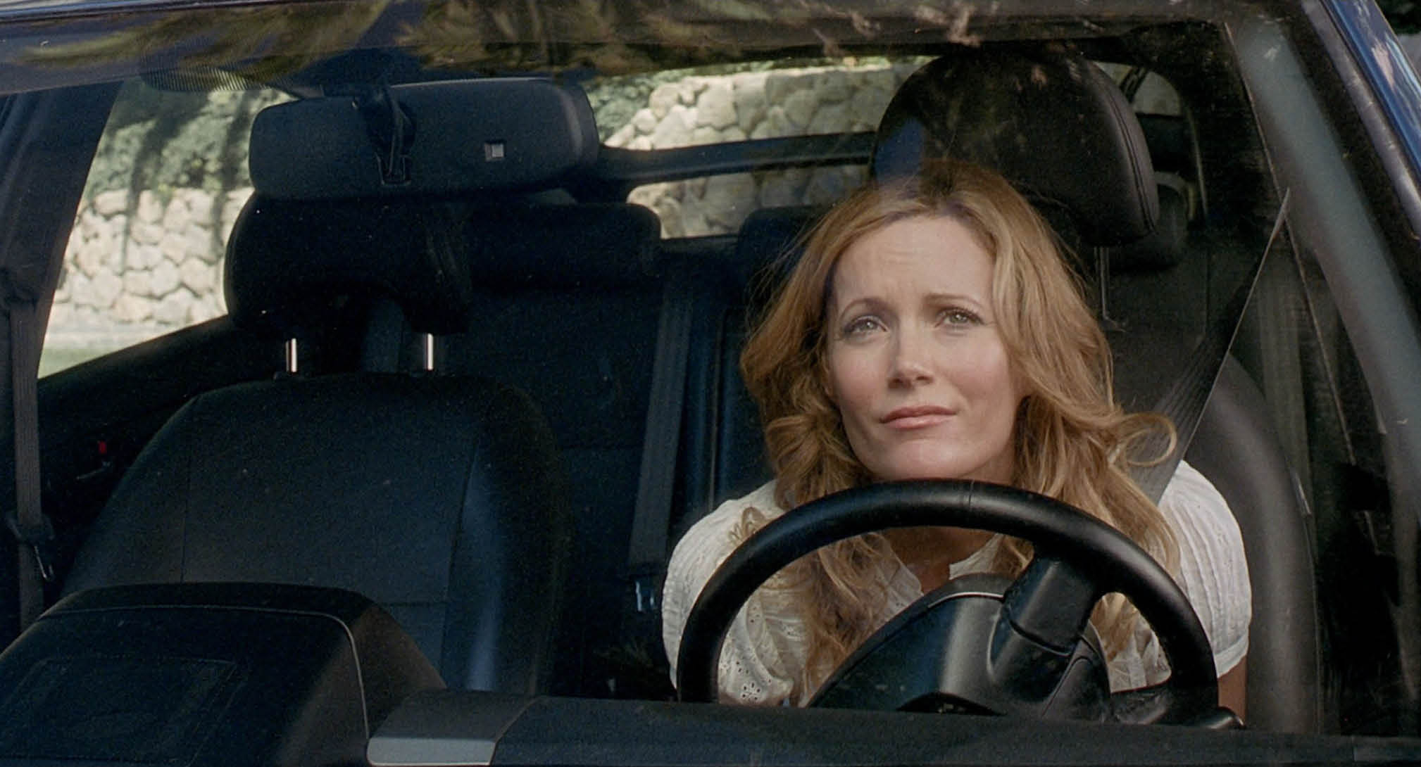 A woman is driving a car. Description generated by AI