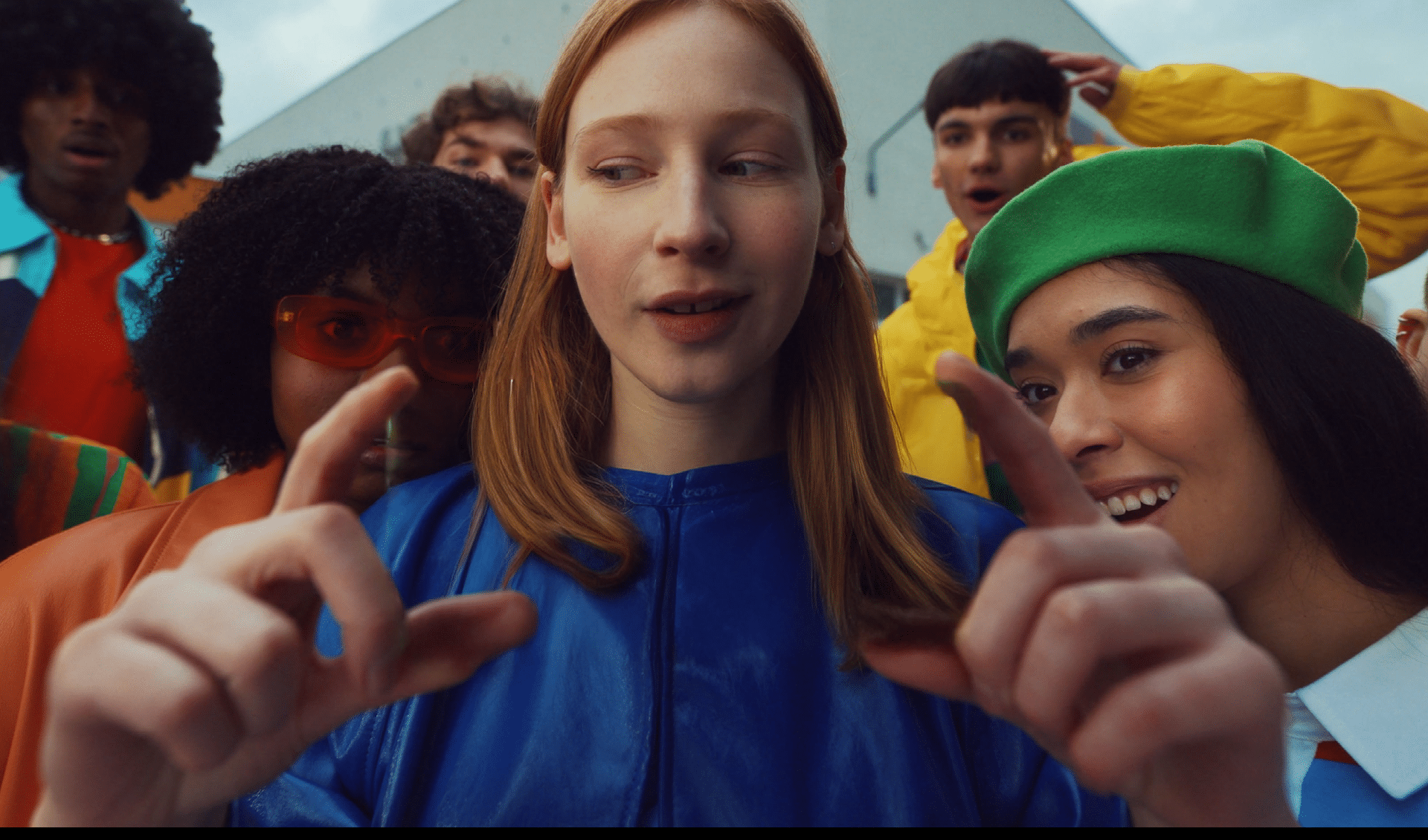 A group of people with different colored hair and clothing. Description generated by AI