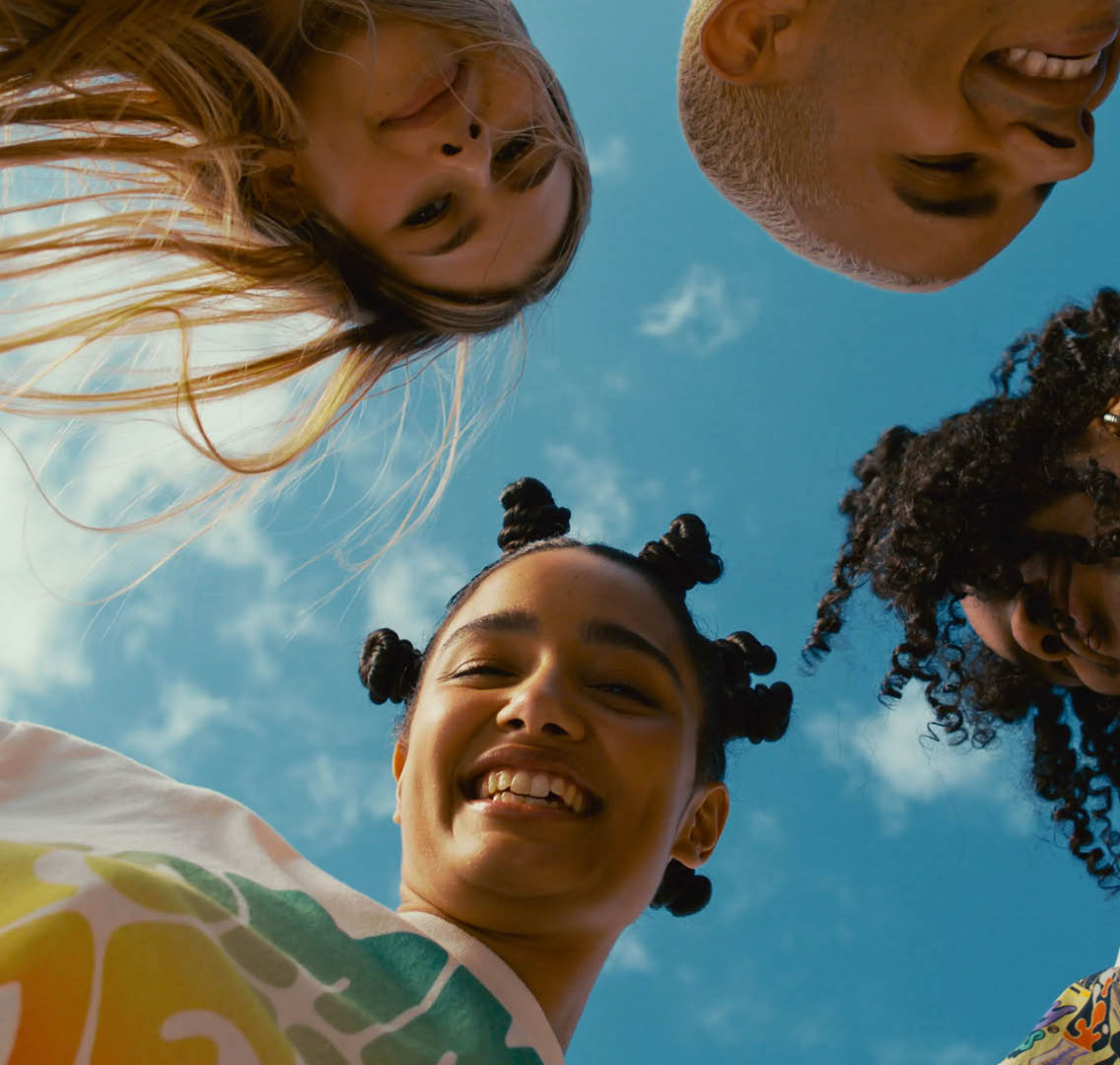 A group of people with dreadlocks smiling and laughing. Description generated by AI