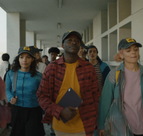 A group of people walking down a hallway. Description generated by AI